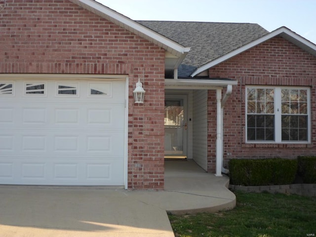 doorway to property with a garage