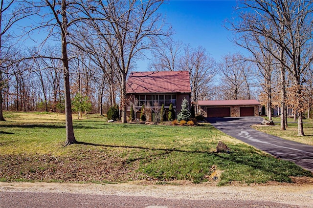 view of front of house featuring a garage and a front lawn