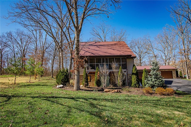 view of front of home featuring a garage and a front lawn