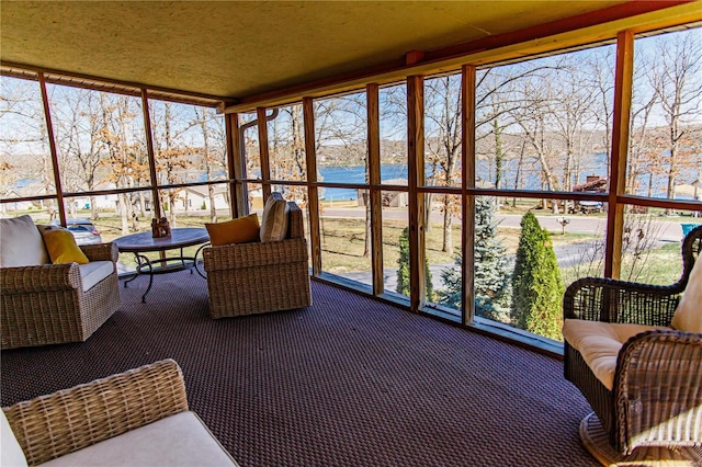 sunroom with a water view and a wealth of natural light