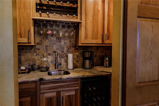 interior space with backsplash, light stone counters, and sink