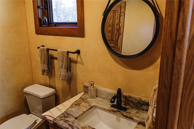 bathroom featuring toilet and vanity