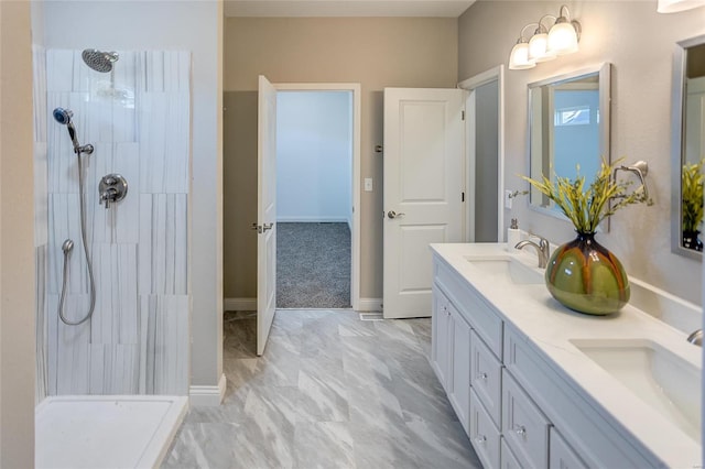 bathroom featuring vanity and tiled shower