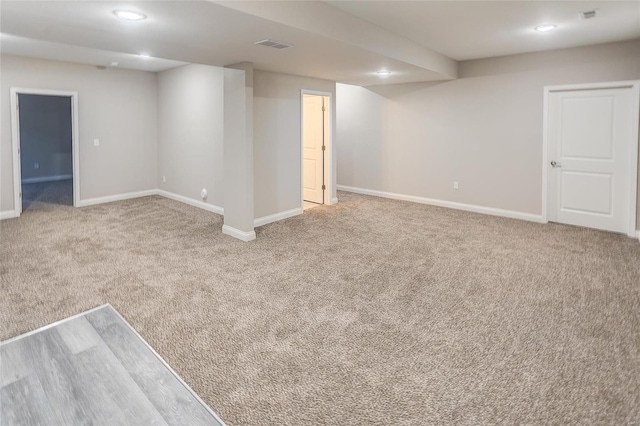 basement featuring light colored carpet