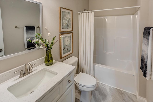 full bathroom featuring toilet, shower / bath combo with shower curtain, and vanity