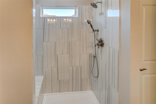 bathroom with a tile shower