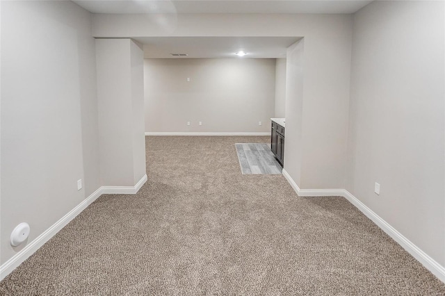 finished below grade area featuring carpet floors and baseboards