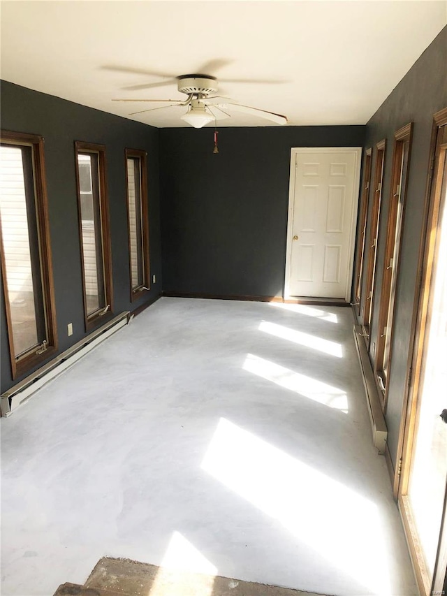 unfurnished room featuring ceiling fan and a baseboard radiator