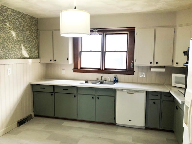 kitchen with white cabinets, white appliances, decorative light fixtures, and sink