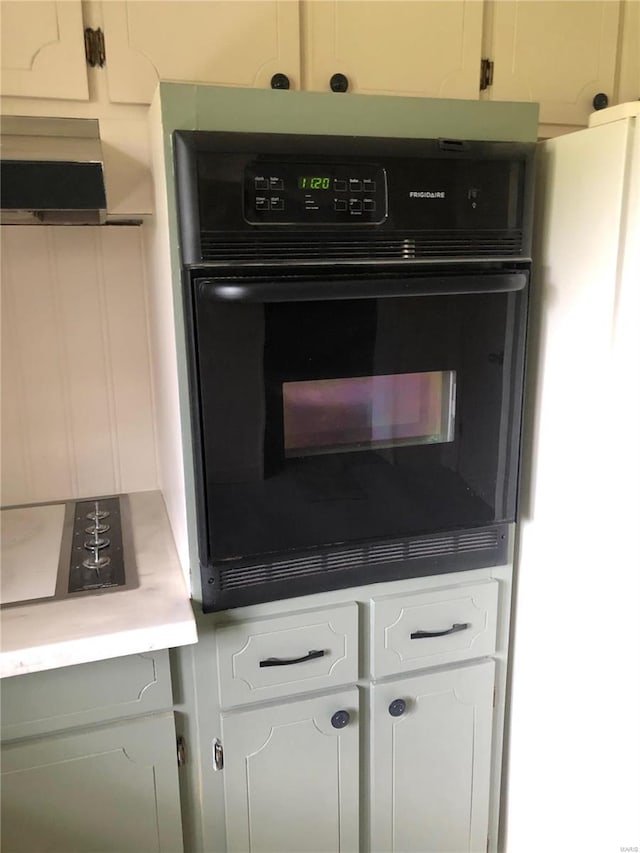 room details with black oven and white cabinets