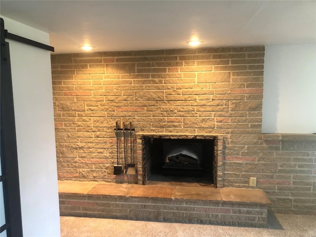 details featuring carpet and a brick fireplace