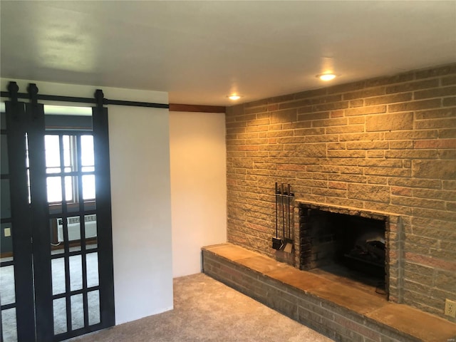 unfurnished living room with carpet flooring and a large fireplace