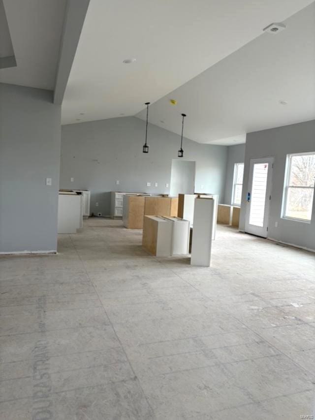 unfurnished living room with vaulted ceiling