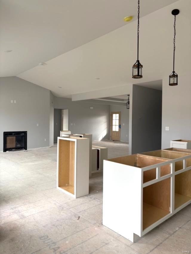 kitchen with hanging light fixtures, a kitchen island, and lofted ceiling