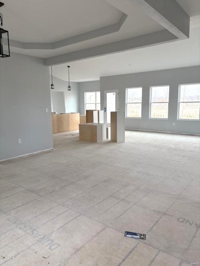 unfurnished room featuring a tray ceiling