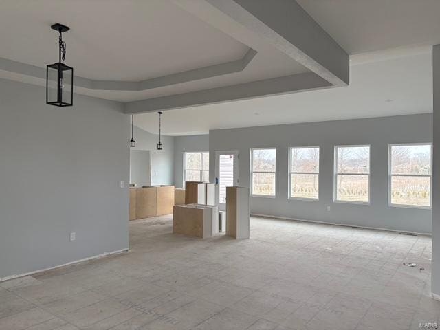 unfurnished living room featuring a raised ceiling