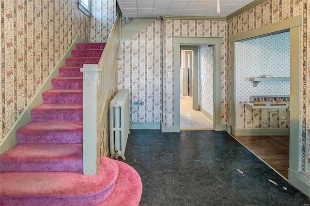 staircase with tile flooring and radiator heating unit