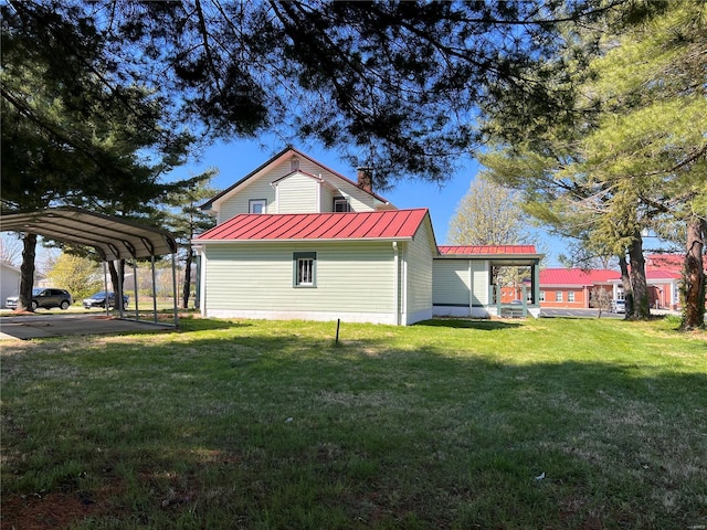 view of home's exterior featuring a lawn and a carport