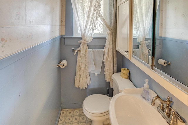 bathroom featuring toilet, tile floors, and sink