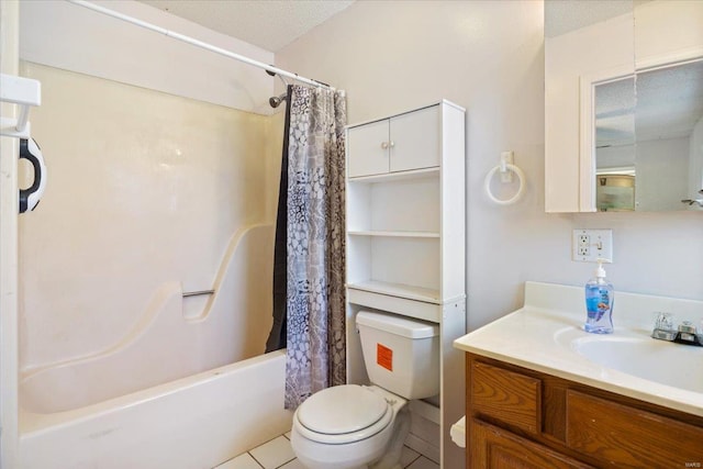 full bathroom with tile patterned floors, vanity, toilet, and a textured ceiling