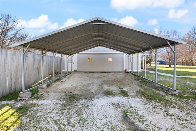 view of vehicle parking with a lawn, a garage, and a carport