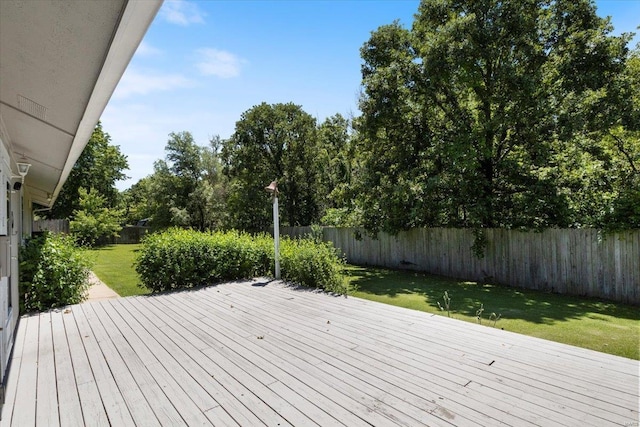 wooden deck featuring a lawn