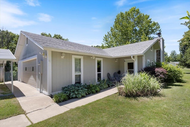 ranch-style house featuring a garage and a front yard