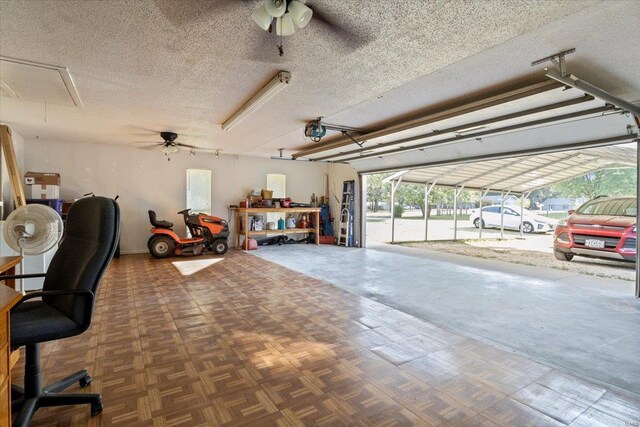 garage with ceiling fan, a garage door opener, and a carport