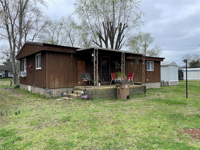 rear view of property featuring a yard