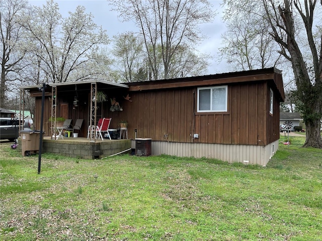 exterior space featuring central AC and a lawn