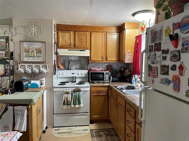 kitchen with white appliances, light tile flooring, and sink