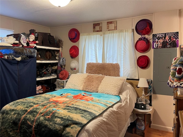 bedroom featuring hardwood / wood-style floors and a textured ceiling