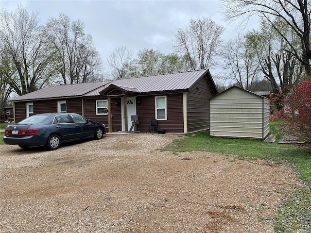 ranch-style house featuring a storage unit