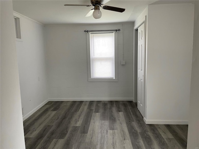 unfurnished room featuring ceiling fan and dark wood-type flooring