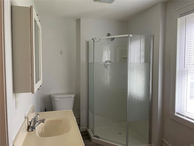 bathroom with an enclosed shower, hardwood / wood-style flooring, large vanity, and toilet