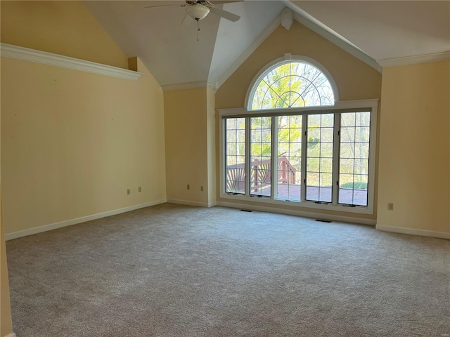 carpeted spare room with crown molding, high vaulted ceiling, and ceiling fan