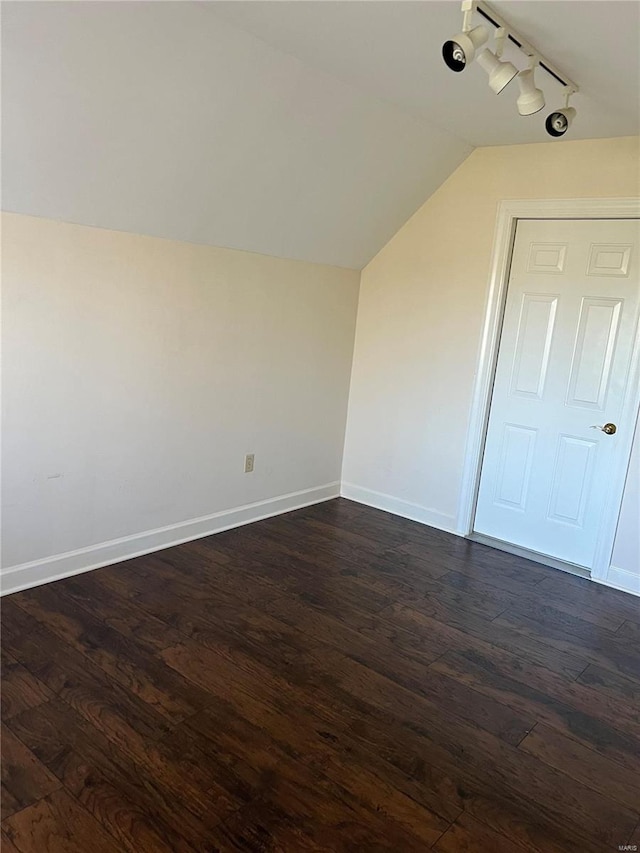 additional living space featuring dark hardwood / wood-style flooring and lofted ceiling