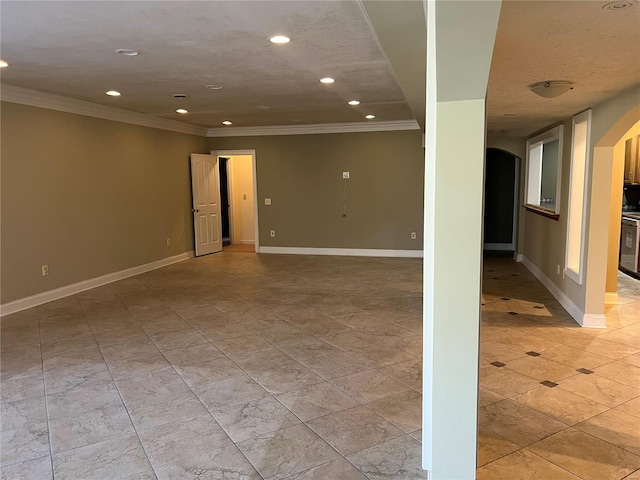 basement featuring light tile floors, a textured ceiling, and crown molding