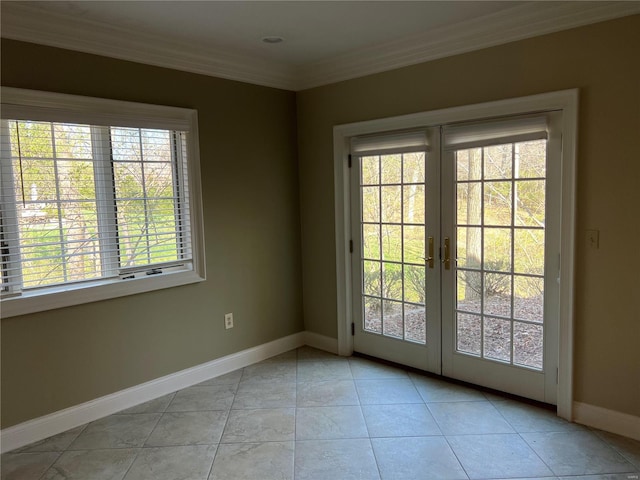 tiled spare room with crown molding and french doors