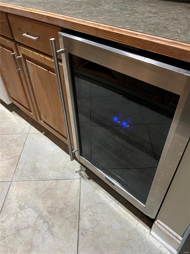 details featuring beverage cooler and light tile floors