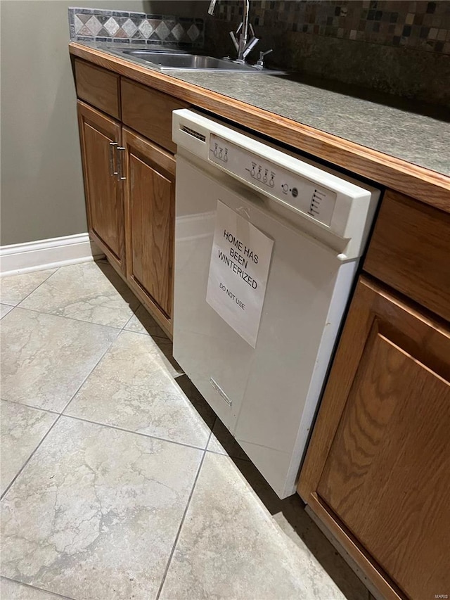 room details featuring white dishwasher, light tile floors, and sink