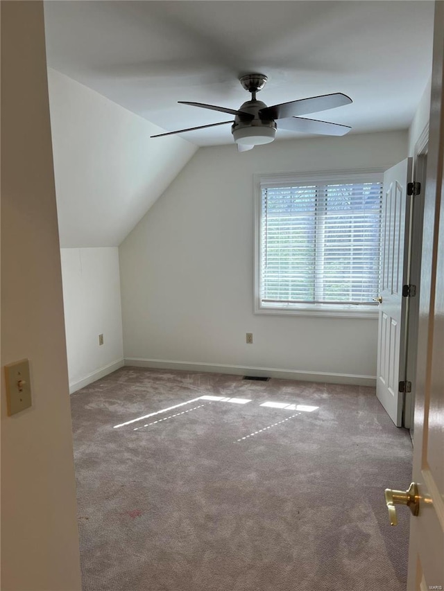 additional living space featuring ceiling fan, lofted ceiling, and light carpet