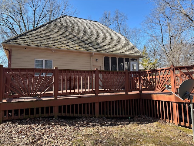 back of property featuring a wooden deck