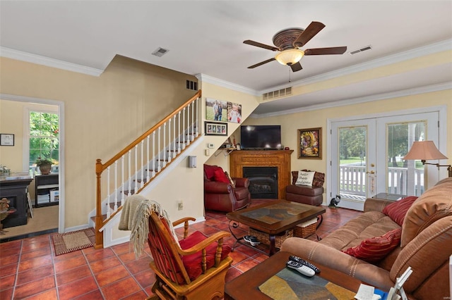 living room featuring ceiling fan, ornamental molding, tile patterned floors, and french doors