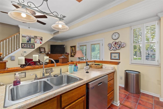 kitchen with tile patterned floors, ornamental molding, dishwasher, ceiling fan, and hanging light fixtures