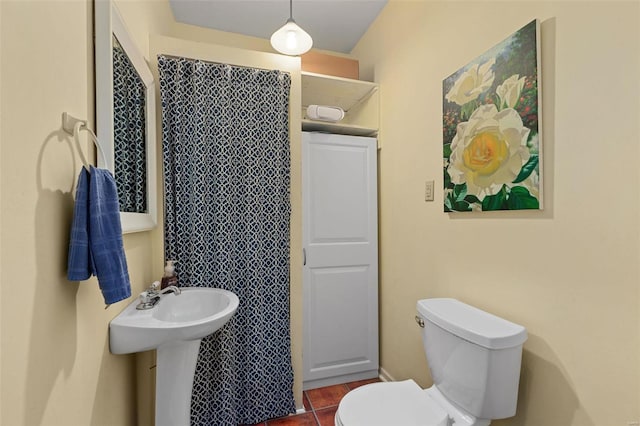 bathroom with toilet and tile patterned floors