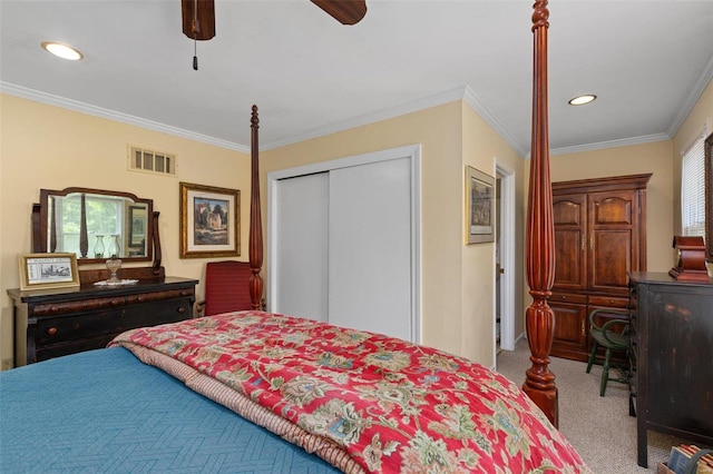 bedroom with ornamental molding, light colored carpet, ceiling fan, and a closet