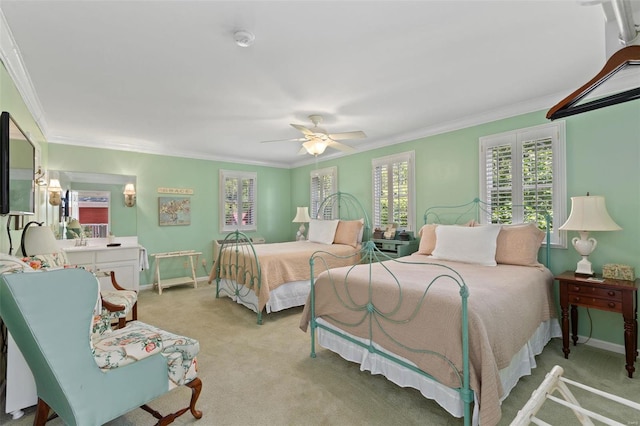 carpeted bedroom with crown molding and ceiling fan