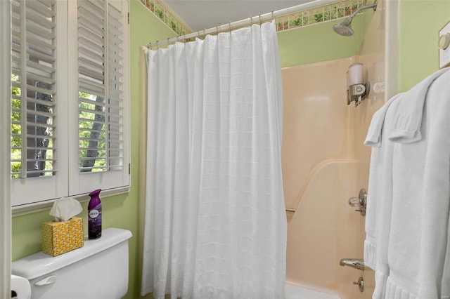 bathroom with toilet and shower / tub combo