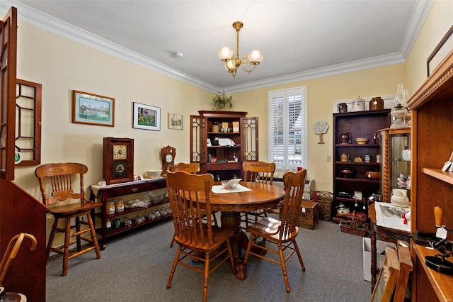 dining area with ornamental molding, carpet floors, and a notable chandelier